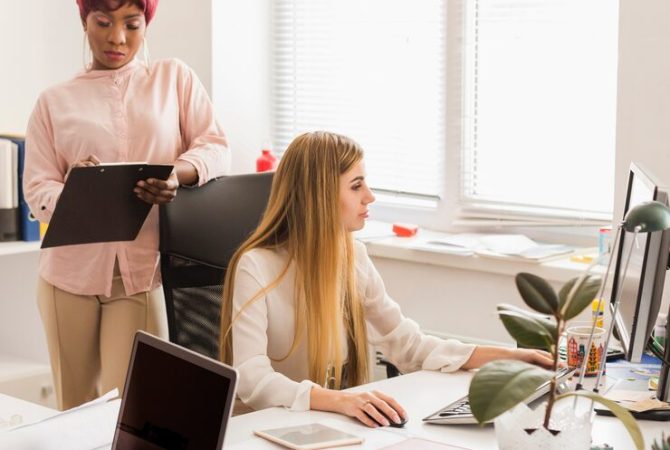 black-woman-with-clipboard-near-working-colleague_23-2147808052 black-woman-with-clipboard-near-working-colleague_23-2147808052